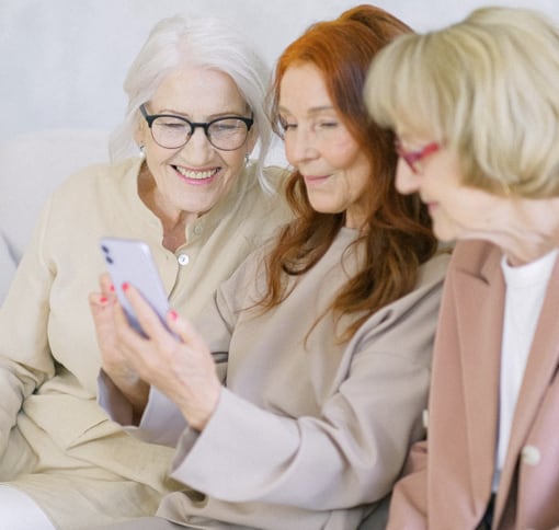 three women videocalling on a phone